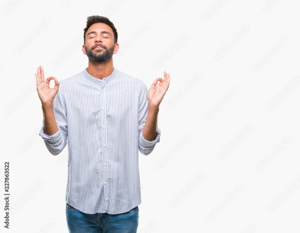 Naklejka premium Adult hispanic man over isolated background relax and smiling with eyes closed doing meditation gesture with fingers. Yoga concept.