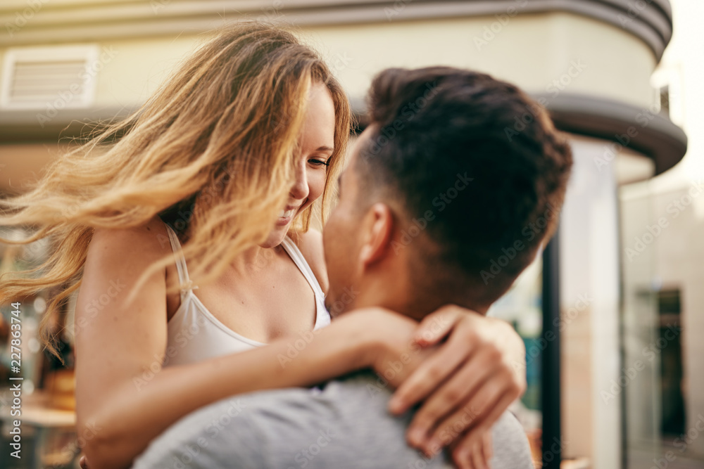 Young couple looking into each other's eyes in the city