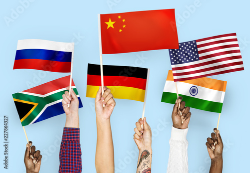 Hands waving flags of China, Germany, India, South Africa, and Russia photo