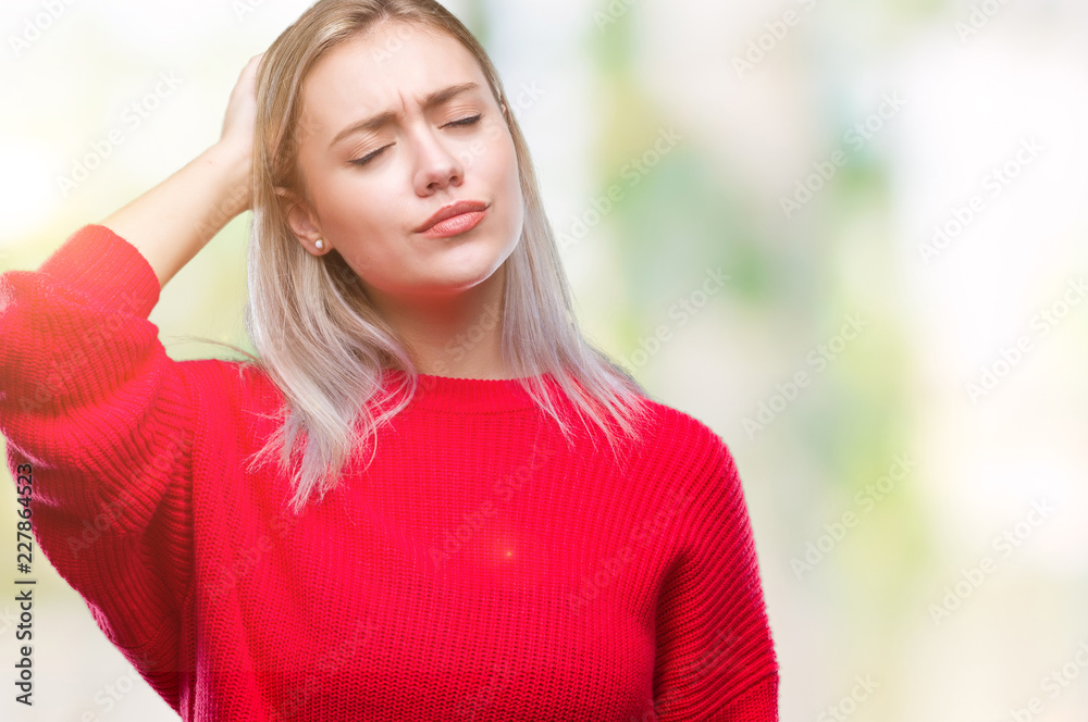 Young blonde woman wearing winter sweater over isolated background confuse and wonder about question. Uncertain with doubt, thinking with hand on head. Pensive concept.