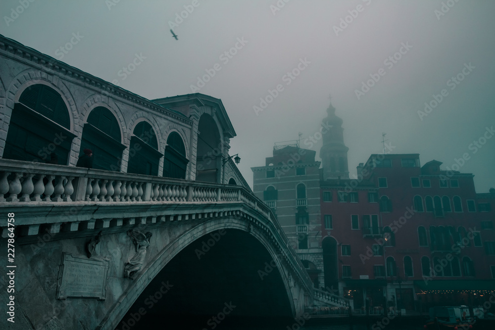 Rialto Bridge in Venice on a dark foggy morning