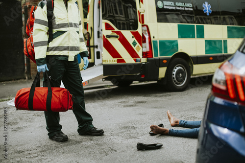 Male paramedic responding to a car accident