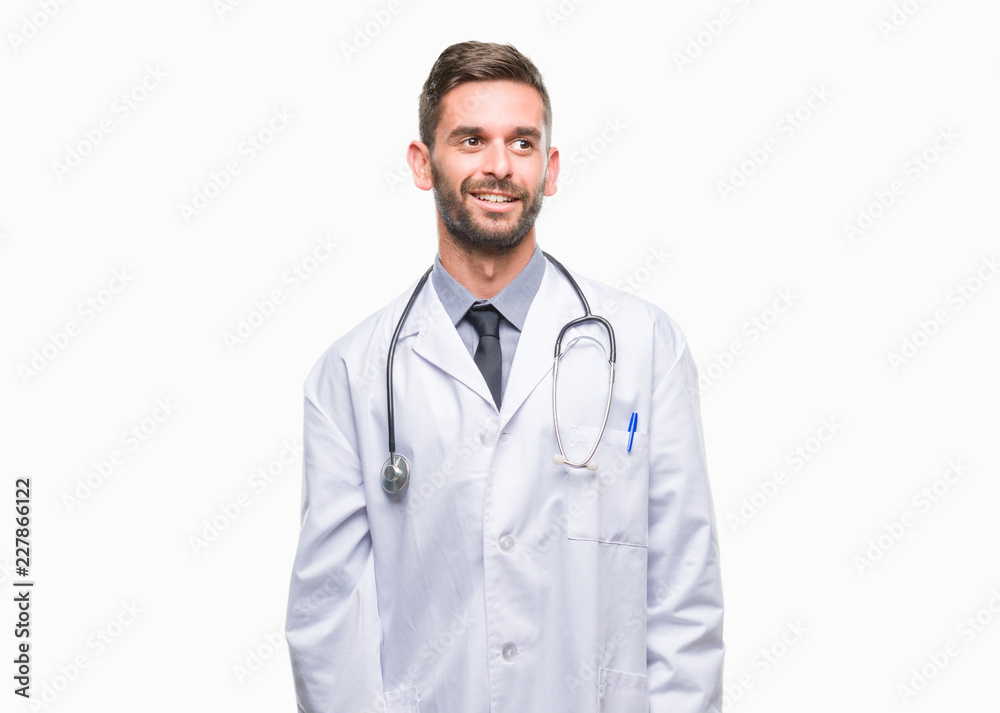Young handsome doctor man over isolated background looking away to side with smile on face, natural expression. Laughing confident. Young handsome doctor man over isolated background looking away to side with smile on face, natural expression. Laughing confident.