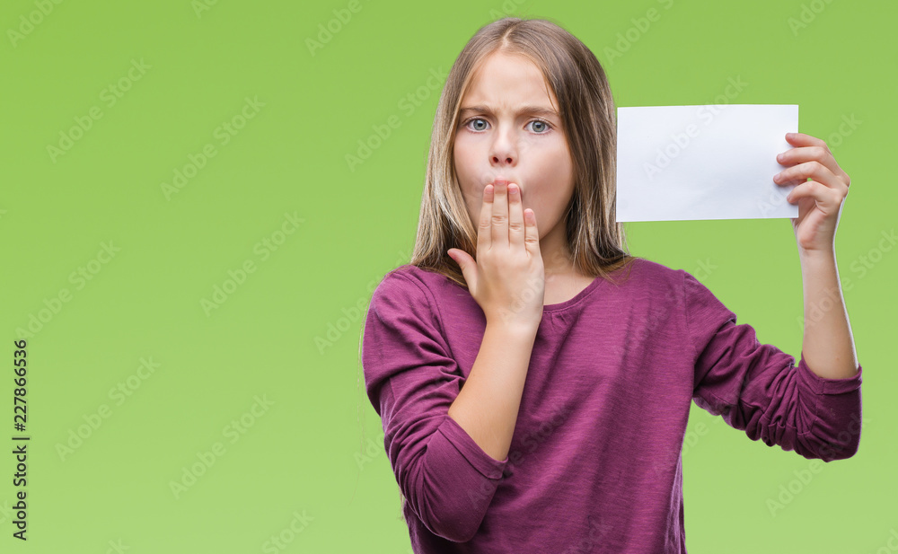 Young beautiful girl holding blank paper card over isolated background cover mouth with hand shocked with shame for mistake, expression of fear, scared in silence, secret concept Young beautiful girl holding blank paper card over isolated background cover mouth with hand shocked with shame for mistake, expression of fear, scared in silence, secret concept