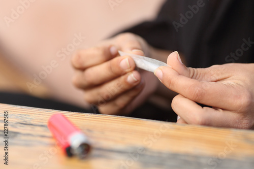 Woman hands making a cigarette