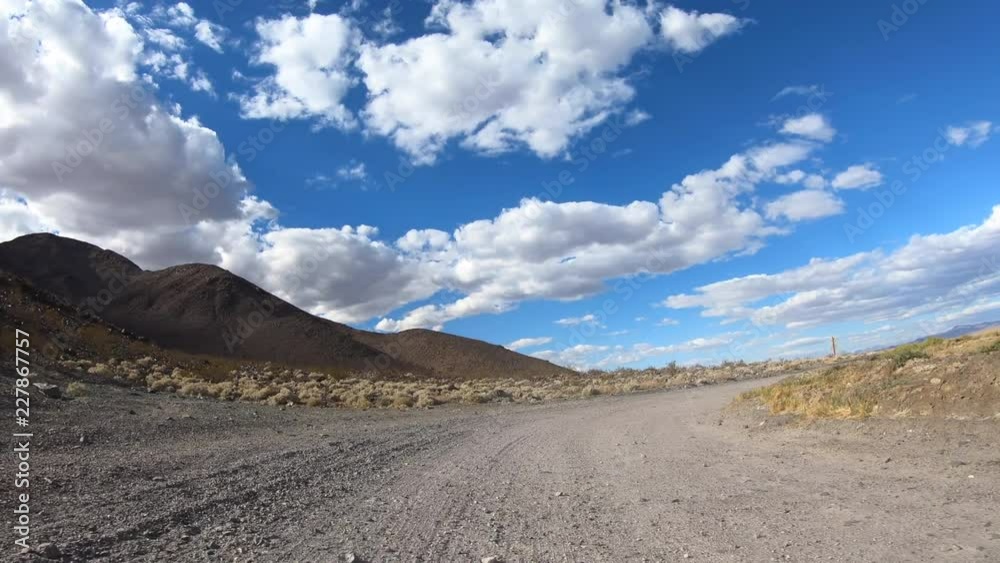 Dirt road rear view driving on Zzyzx Road near Baker the California Mojave desert. Dirt road rear view driving on Zzyzx Road near Baker the California Mojave desert.