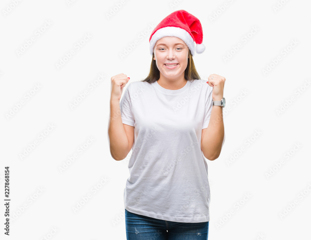 Young beautiful caucasian woman wearing christmas hat over isolated background celebrating surprised and amazed for success with arms raised and open eyes. Winner concept. Young beautiful caucasian woman wearing christmas hat over isolated background celebrating surprised and amazed for success with arms raised and open eyes. Winner concept.