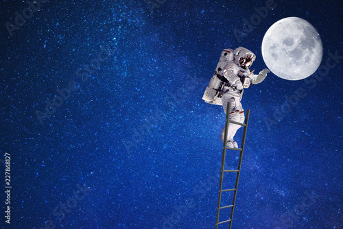 astronaut in outer space on ladder and moon.elements of this image furnished by NASA