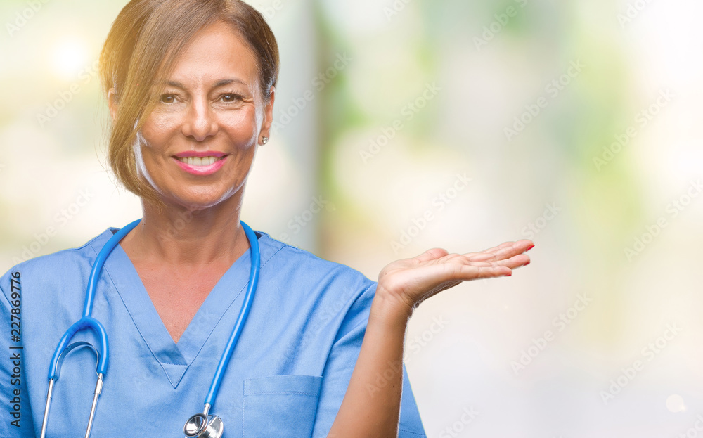 Middle age senior nurse doctor woman over isolated background smiling cheerful presenting and pointing with palm of hand looking at the camera. Middle age senior nurse doctor woman over isolated background smiling cheerful presenting and pointing with palm of hand looking at the camera.