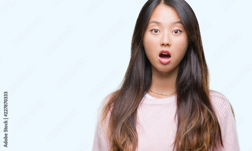 Young asian woman over isolated background afraid and shocked with surprise expression, fear and excited face. Young asian woman over isolated background afraid and shocked with surprise expression, fear and excited face.