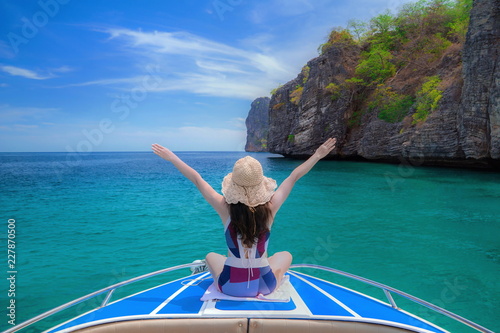 Cute girl is relaxing in the summer at the sea.Traveling by the sea.Holidays in the summer.Beautiful sea of Thailand.Summer sea travel.Summer beach travel.