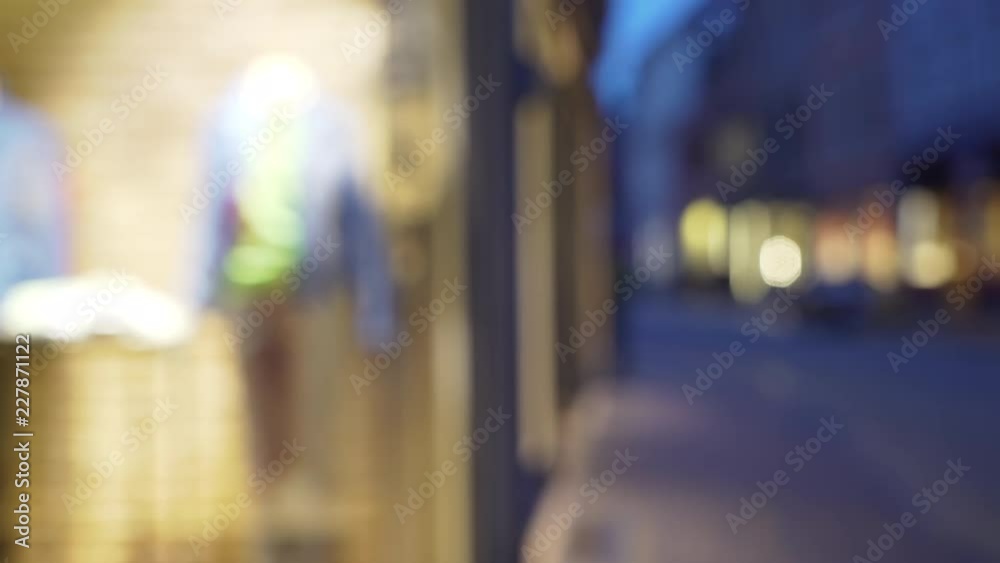 Out of focus background plate of city street in shopping district at night