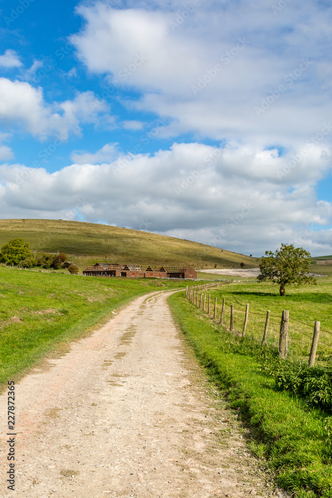 A country path leading to disused farm buildings A country path leading to disused farm buildings
