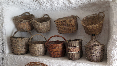 Slika na platnu Handmade baskets on display in limestone cave alcove