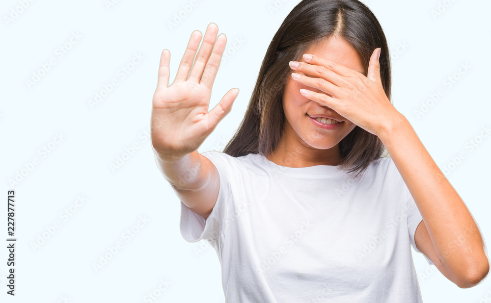 Young asian woman over isolated background covering eyes with hands and doing stop gesture with sad and fear expression. Embarrassed and negative concept. Young asian woman over isolated background covering eyes with hands and doing stop gesture with sad and fear expression. Embarrassed and negative concept.