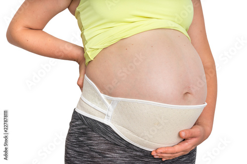 Pregnant woman with orthopedic belly belt isolated on white © andriano_cz