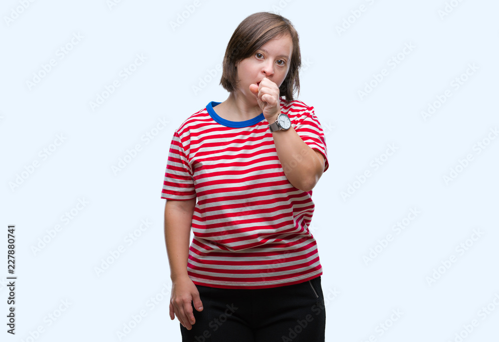 Young adult woman with down syndrome over isolated background feeling unwell and coughing as symptom for cold or bronchitis. Healthcare concept. Young adult woman with down syndrome over isolated background feeling unwell and coughing as symptom for cold or bronchitis. Healthcare concept.