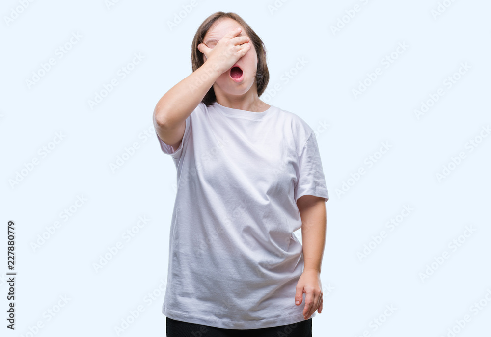 Young adult woman with down syndrome over isolated background peeking in shock covering face and eyes with hand, looking through fingers with embarrassed expression. Young adult woman with down syndrome over isolated background peeking in shock covering face and eyes with hand, looking through fingers with embarrassed expression.