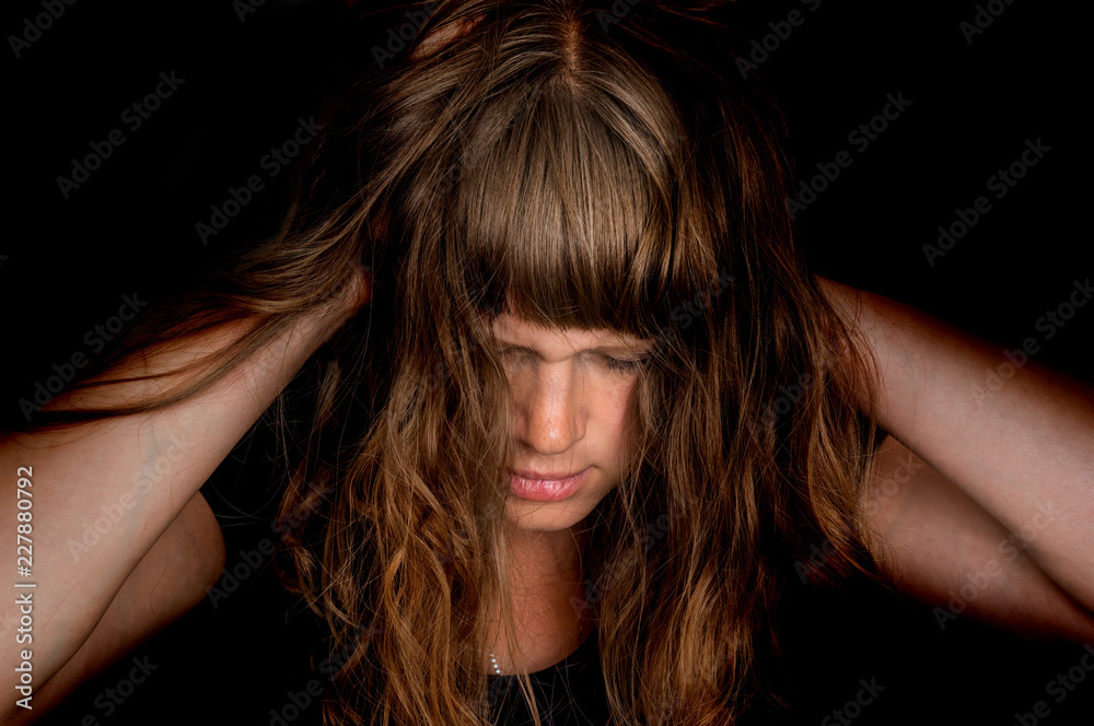 Depressed woman with hands in her hair