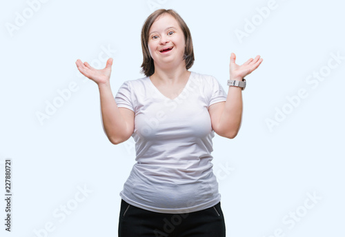 Young adult woman with down syndrome over isolated background crazy and mad shouting and yelling with aggressive expression and arms raised. Frustration concept. © Krakenimages.com