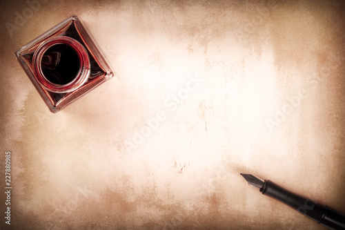 Принти на полотні A vintage background with an ink pen and an ink well, shot from above, in sepia