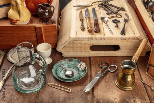 A photo of many vintage objects, flea market stuff on a wooden table photo