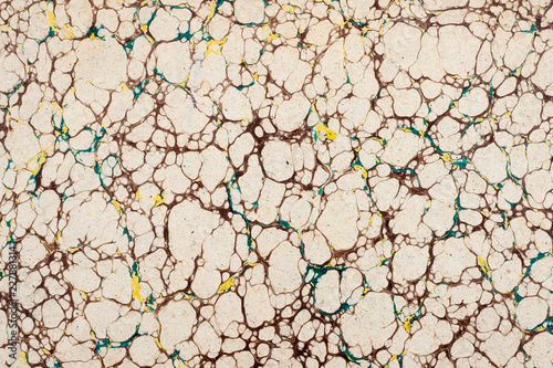 Vintage beige marble paper texture background with a brown basic pattern and yellow and turquoise spots