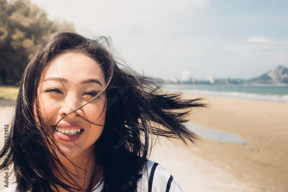 Happy and playful woman walking on the beach. Happy and playful woman walking on the beach.