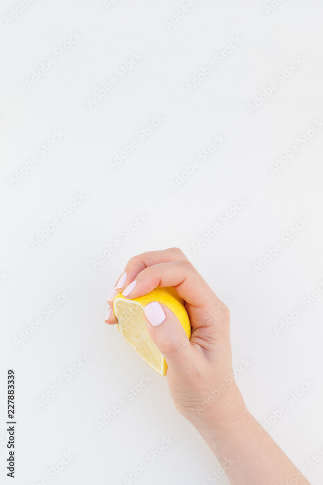 Fototapeta premium Woman hand with lemon