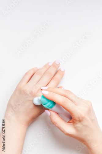 Woman moisturizing her hands with foam lotion