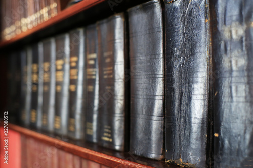 Stack of old books on a library shelf