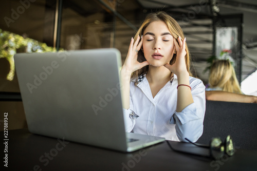 Lifestyle freelance woman working woman and laptop computer he headache unhappy on job in coffee cafe shop