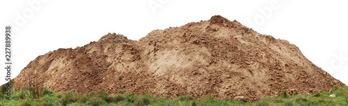 A large pile of construction sand  on forest grassy site. photo