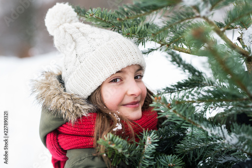 A small girl having fun in snow.