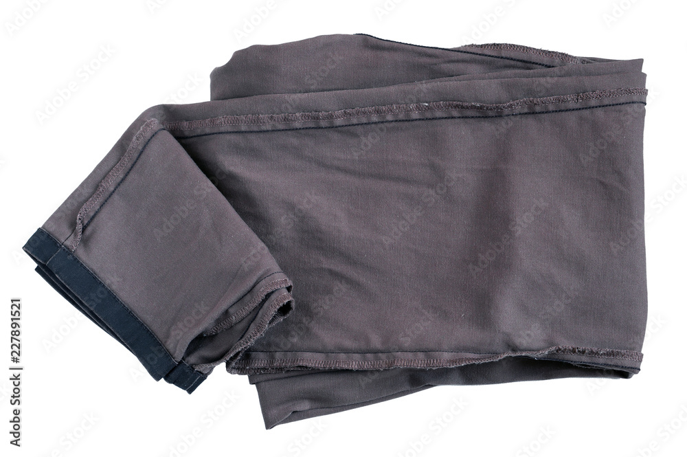 A clean, washed women's jeans trousers lay on a white bed cover A clean, washed women's jeans trousers lay on a white bed cover