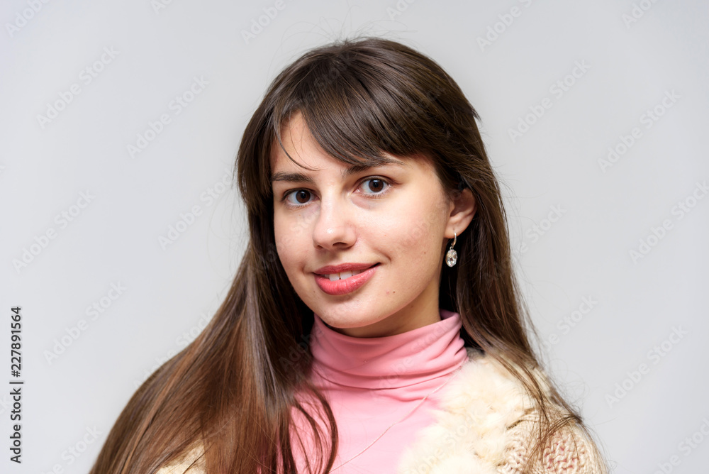 Studio photo of a beautiful brunette girl on a white background with different emotions. Studio photo of a beautiful brunette girl on a white background with different emotions.