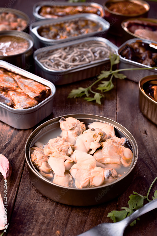 group of open cans of seafood on wood group of open cans of seafood on wood