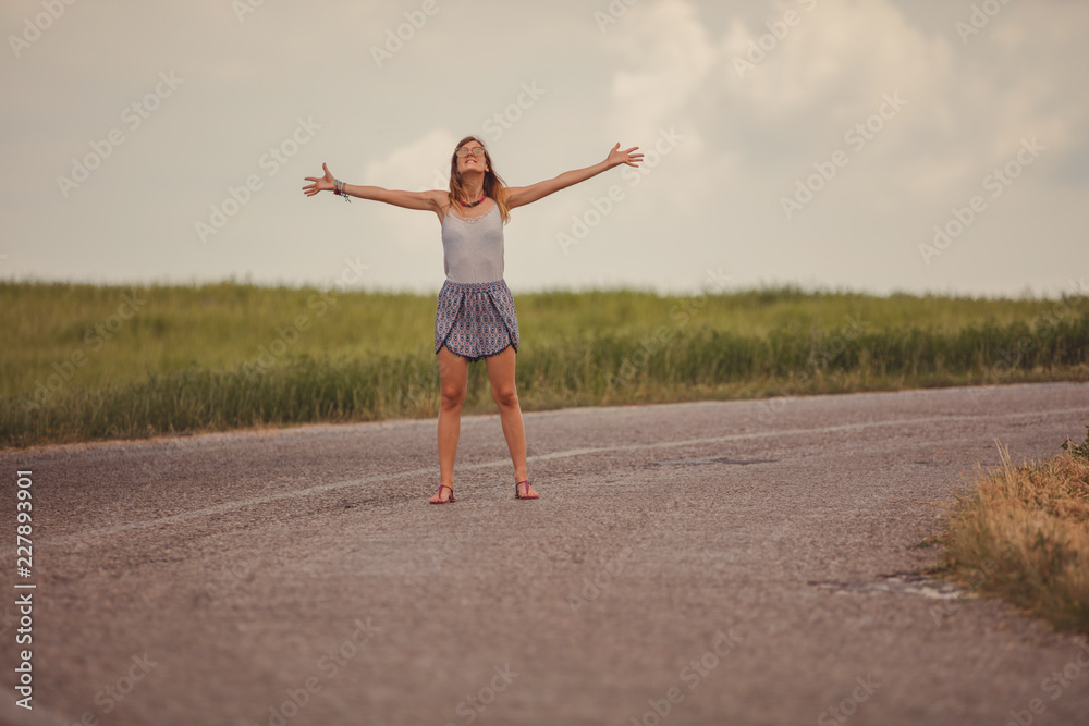 Fototapeta premium Girl enjoying on a empty suburb road.