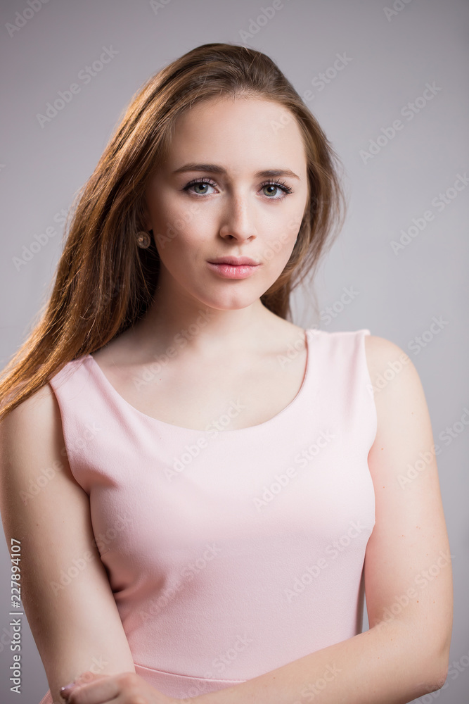 Close up portrait of beautiful young women with long hair and no makeup on grey background Close up portrait of beautiful young women with long hair and no makeup on grey background