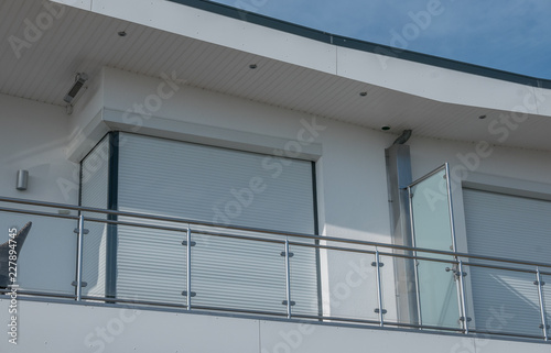 Fenster mit Rolladen und Balkonbrüstung