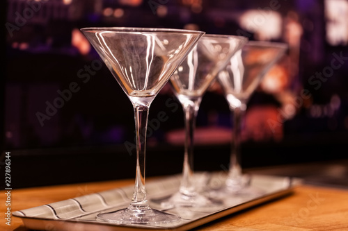 Empty martini glasses on blurred background