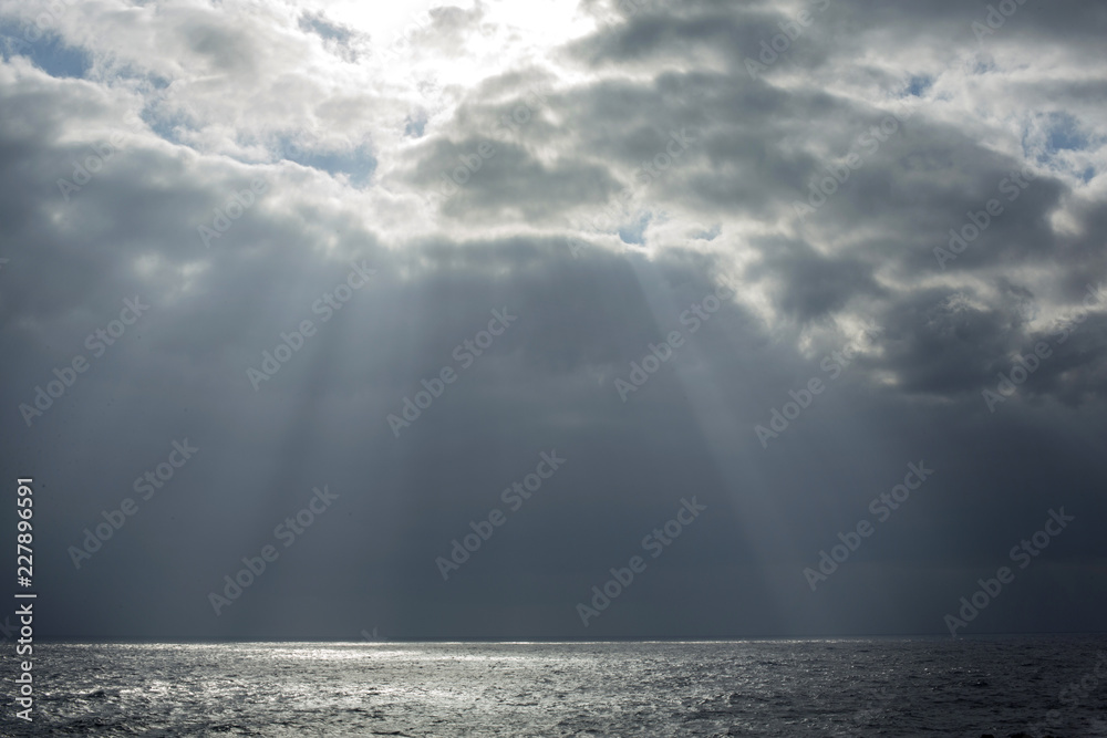 rays of light through the clouds falling on the sea