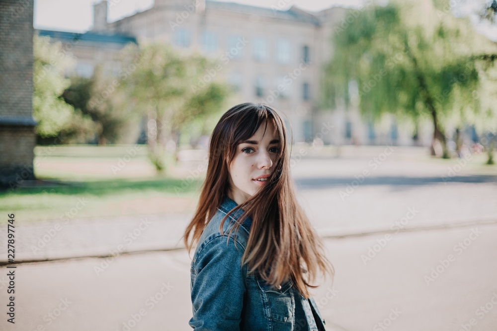 Young cute girl walking in city park Young cute girl walking in city park