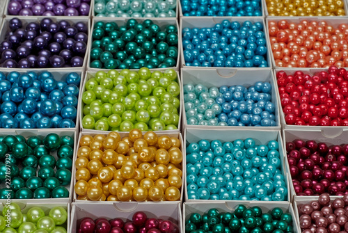 close up multi colored beads heap in box