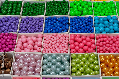 close up multi colored beads heap in box