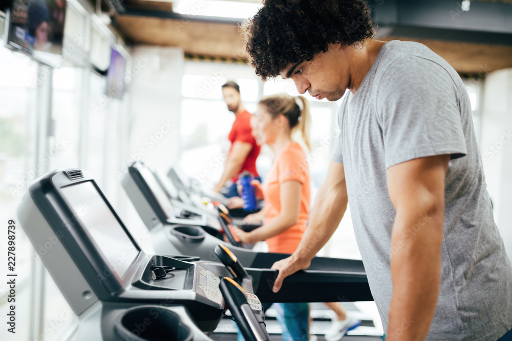Young handsome man doing cardio training in gym Young handsome man doing cardio training in gym