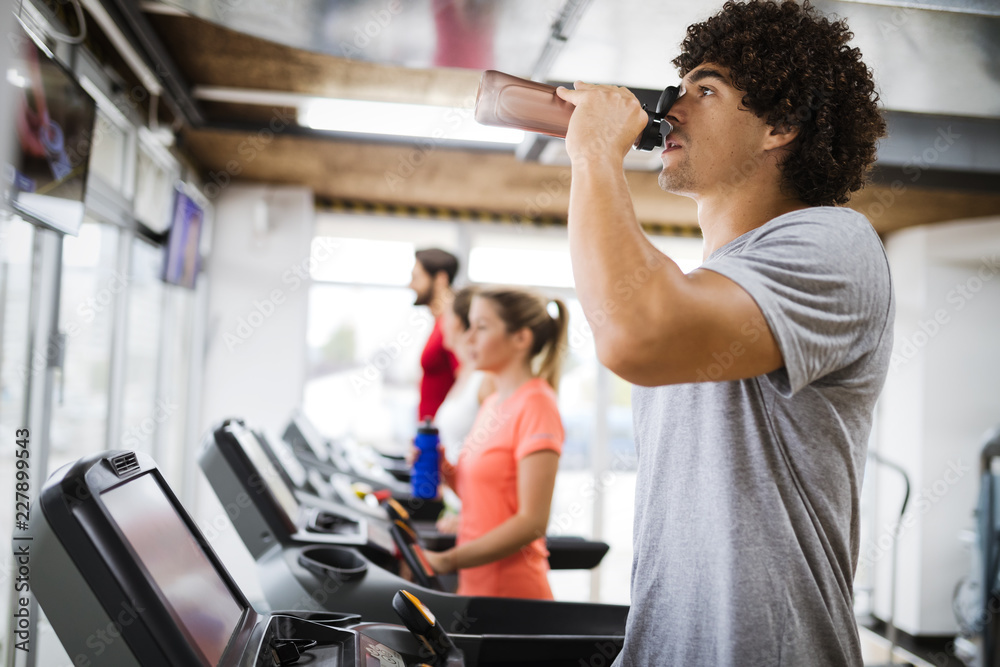 Young handsome man doing cardio training in gym Young handsome man doing cardio training in gym