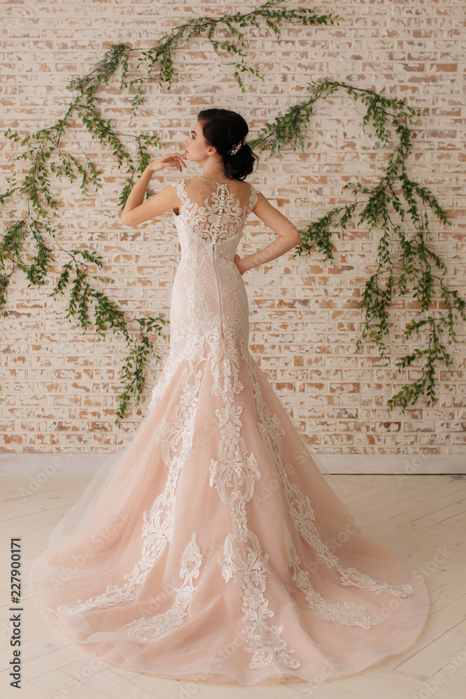Beautiful beige wedding dress on bride Wedding preparation concept