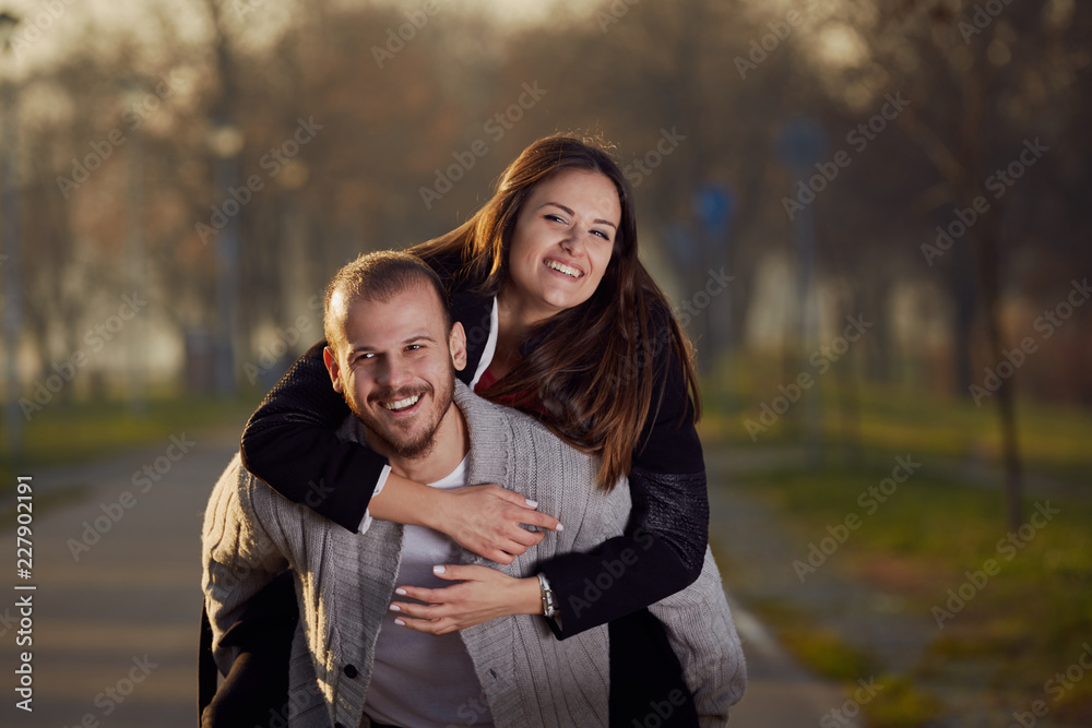 Fototapeta premium Couple using cellphone while drinking coffee outdoors.