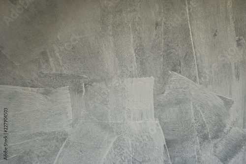 Grey surface of grunge concrete wall just painted with white primer paint as abstract textured background.